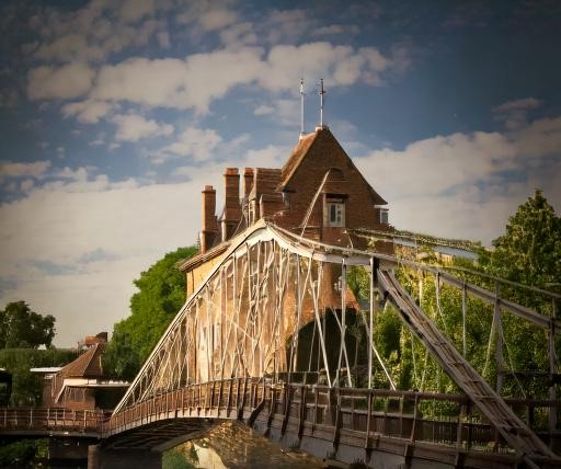 "Historic bridge with brick building."