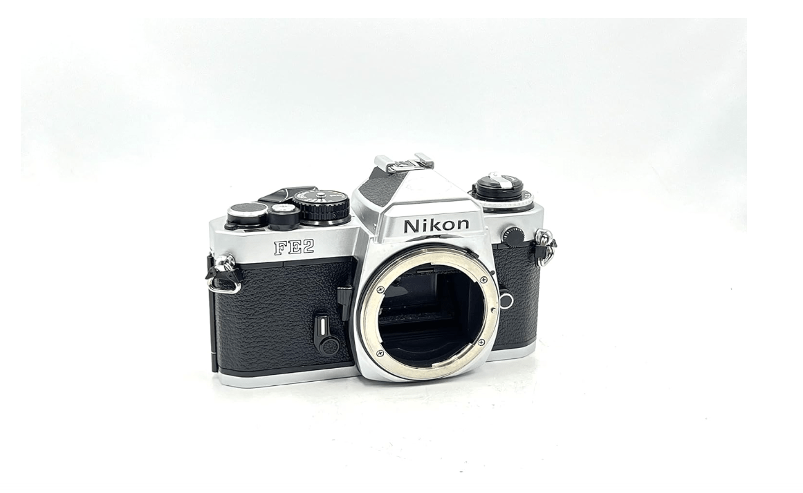 
Nikon FE2 film SLR camera with chrome body; no lens