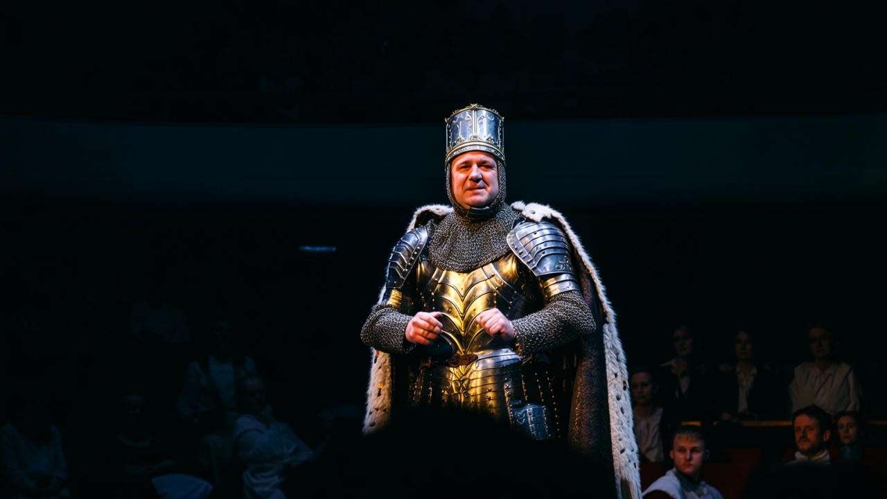 Theater performance of King Henry V delivering a speech to an engaged audience