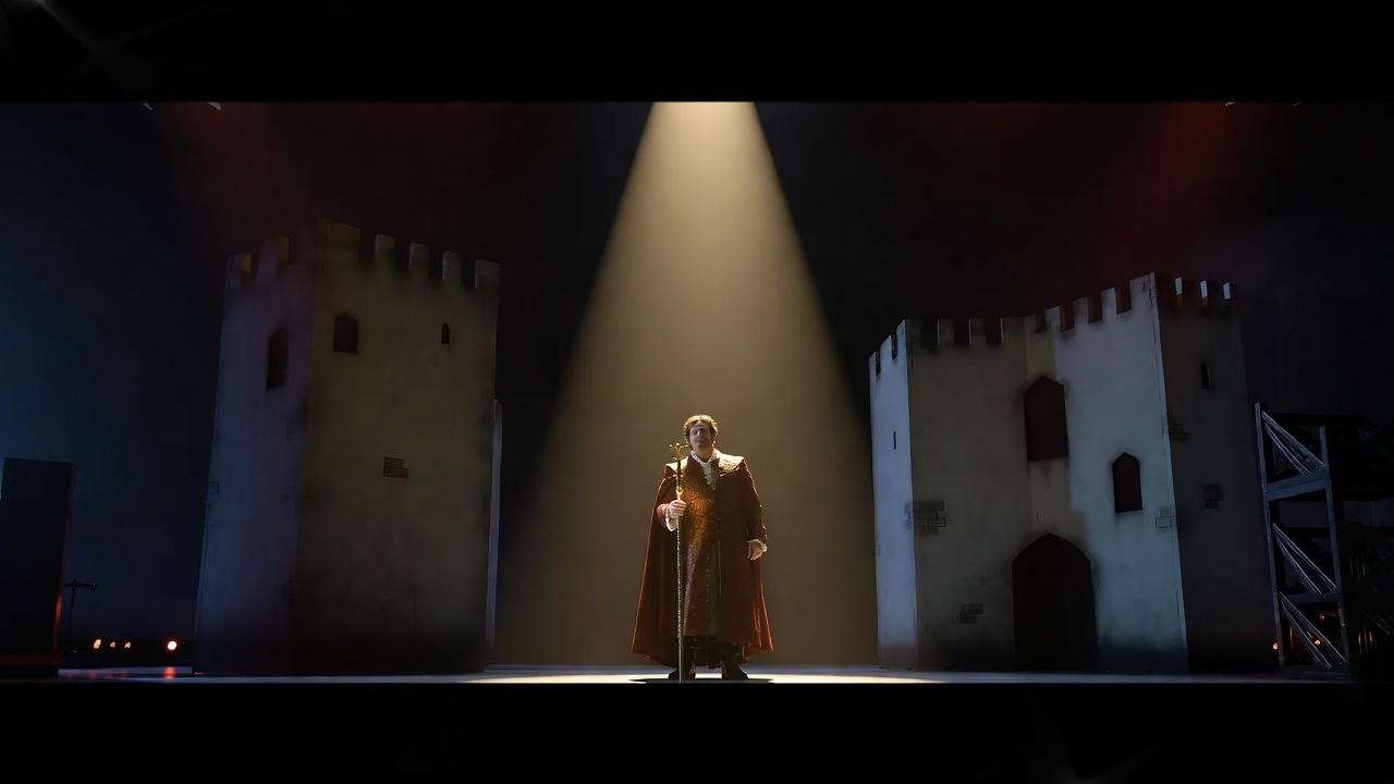 Actor performing the monologue in Act 3 of Macbeth on a dimly lit stage, highlighting the dramatic intensity of Shakespeare’s tragedy.