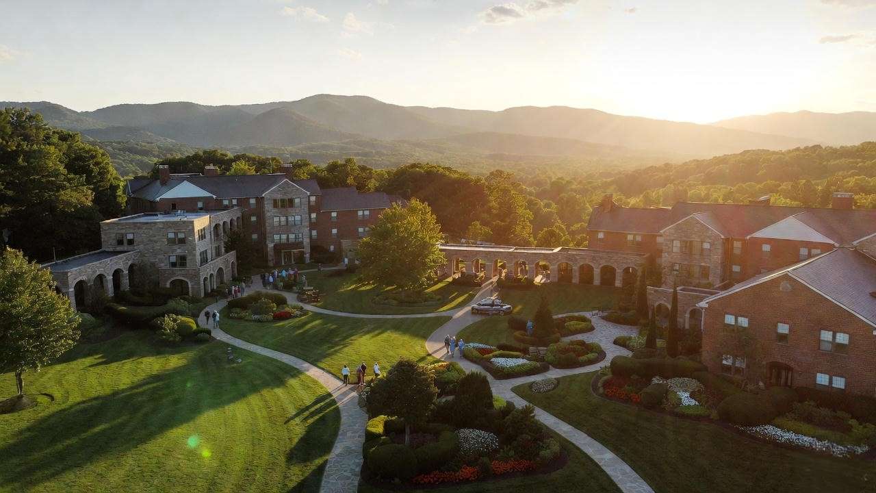 Aerial view of Julian Woods Retirement Community campus with Blue Ridge Mountains at sunset