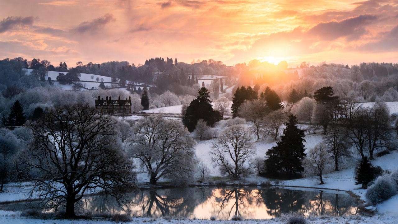 Golden Christmas morning sunrise over snowy Tudor countryside