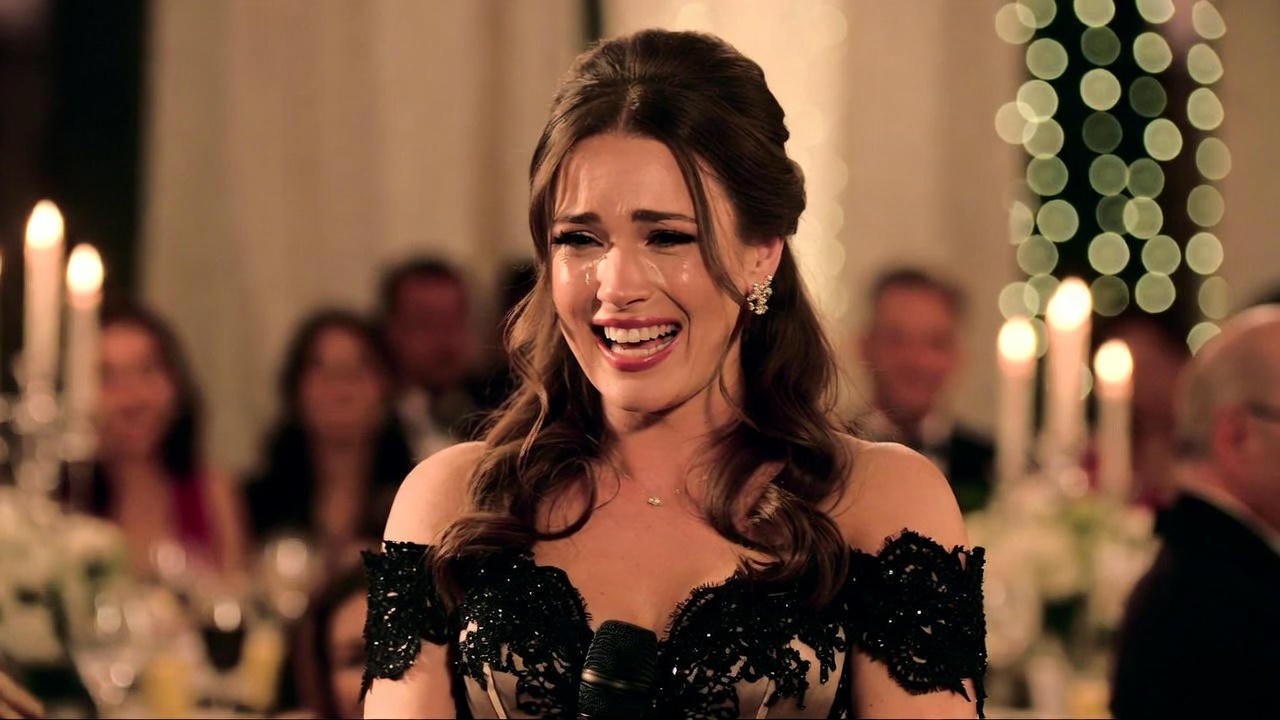 Maid of honor delivering funny yet emotional sister speech at wedding reception