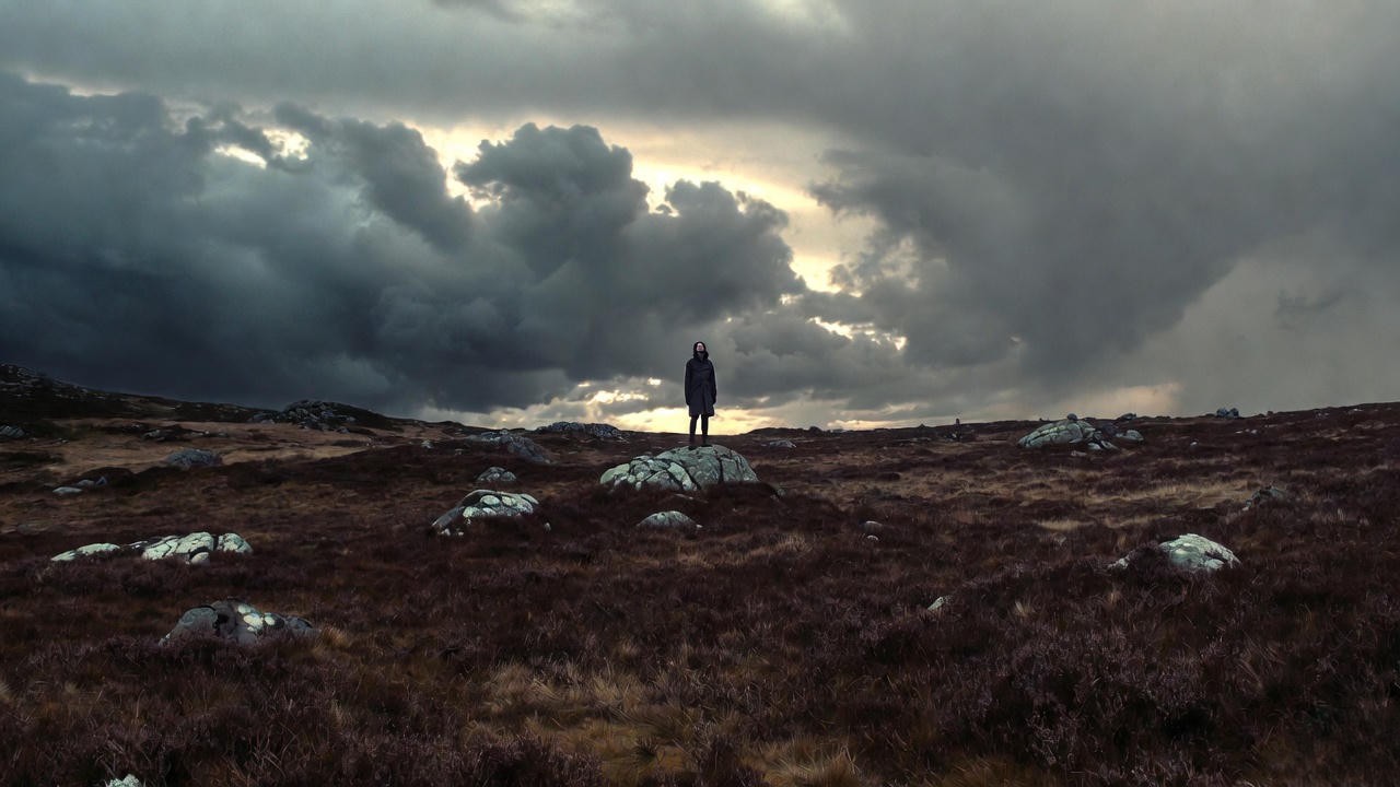 Lone figure on desolate heath representing Edgar’s “Ripeness is all” in King Lear
