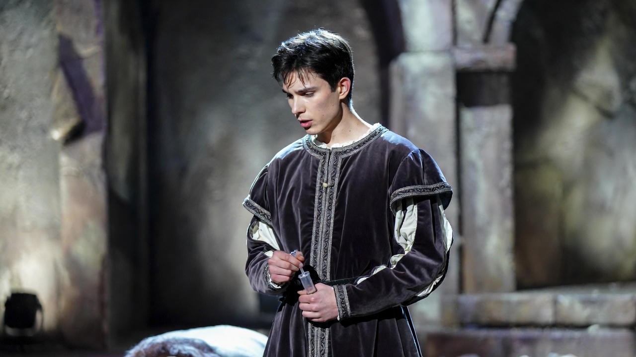 Romeo in the tomb on stage, dramatic theatrical portrayal of the final scene in Romeo and Juliet