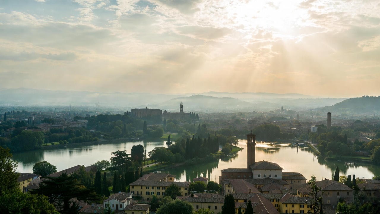 Scenic lakeside view of Renaissance Mantua with Palazzo Ducale, symbolizing Romeo's place of exile in Romeo and Juliet.
