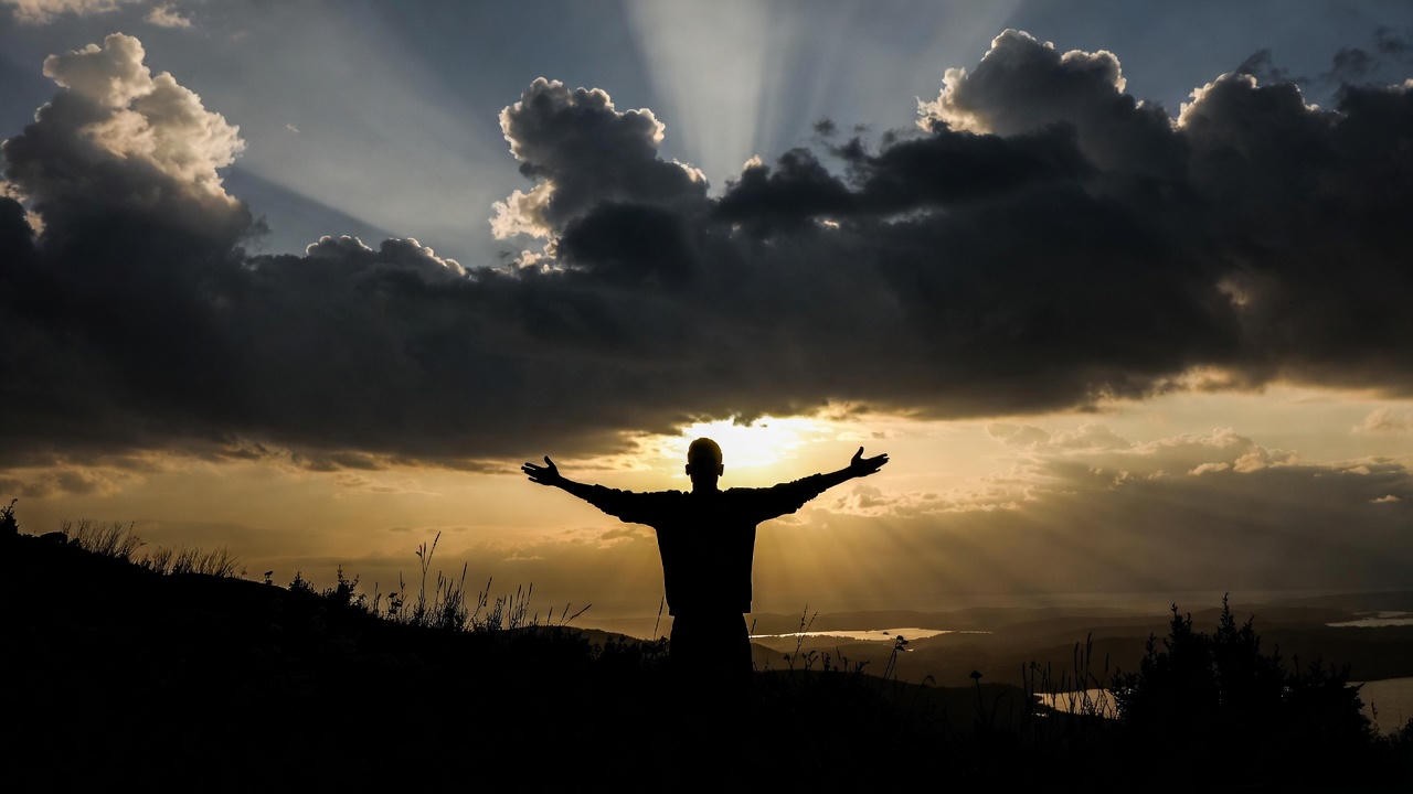 Symbolic figure emerging into dawn light representing overcoming anxiety and finding hope