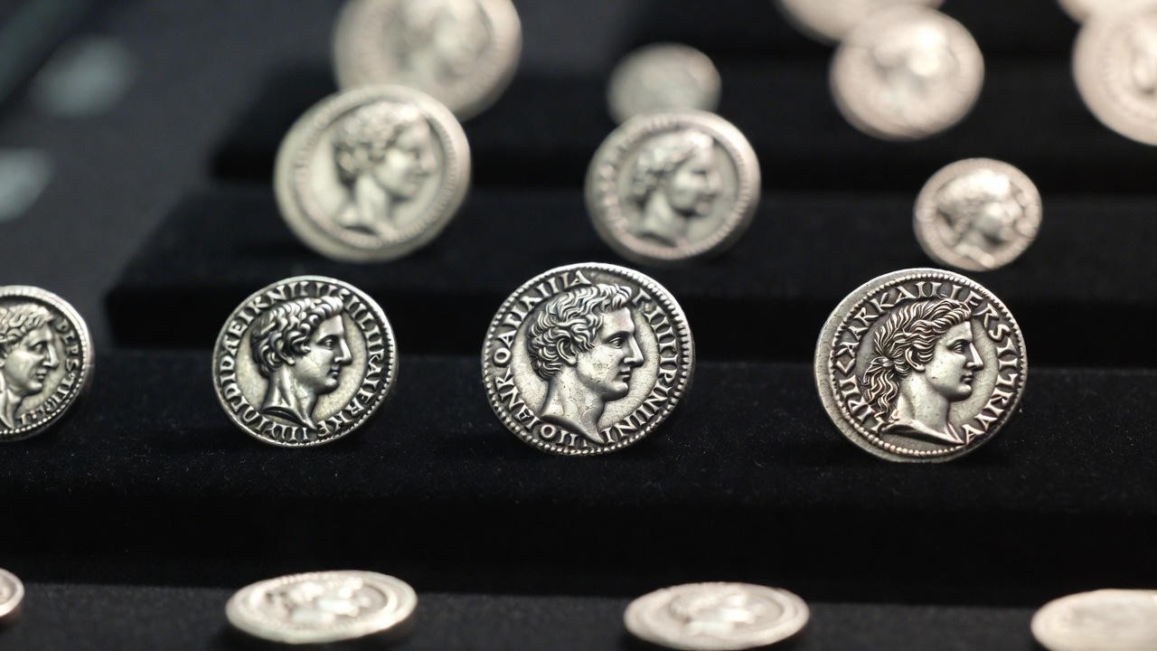 Collection of rare Julius Caesar ancient Roman denarii on display, showcasing historical silver coins for modern collectors