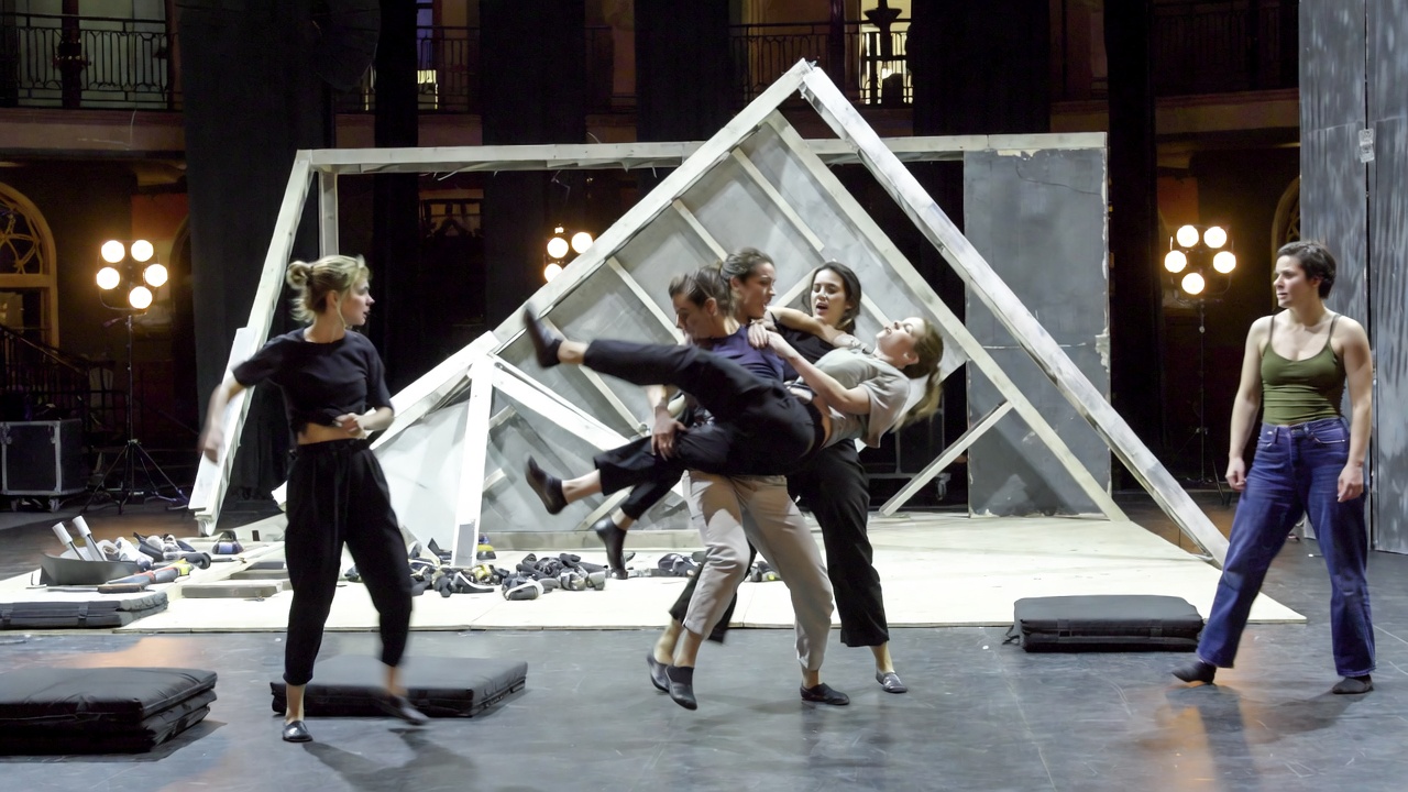 Actors rehearsing safe physical comedy falls and lifts for The Play That Goes Wrong roles