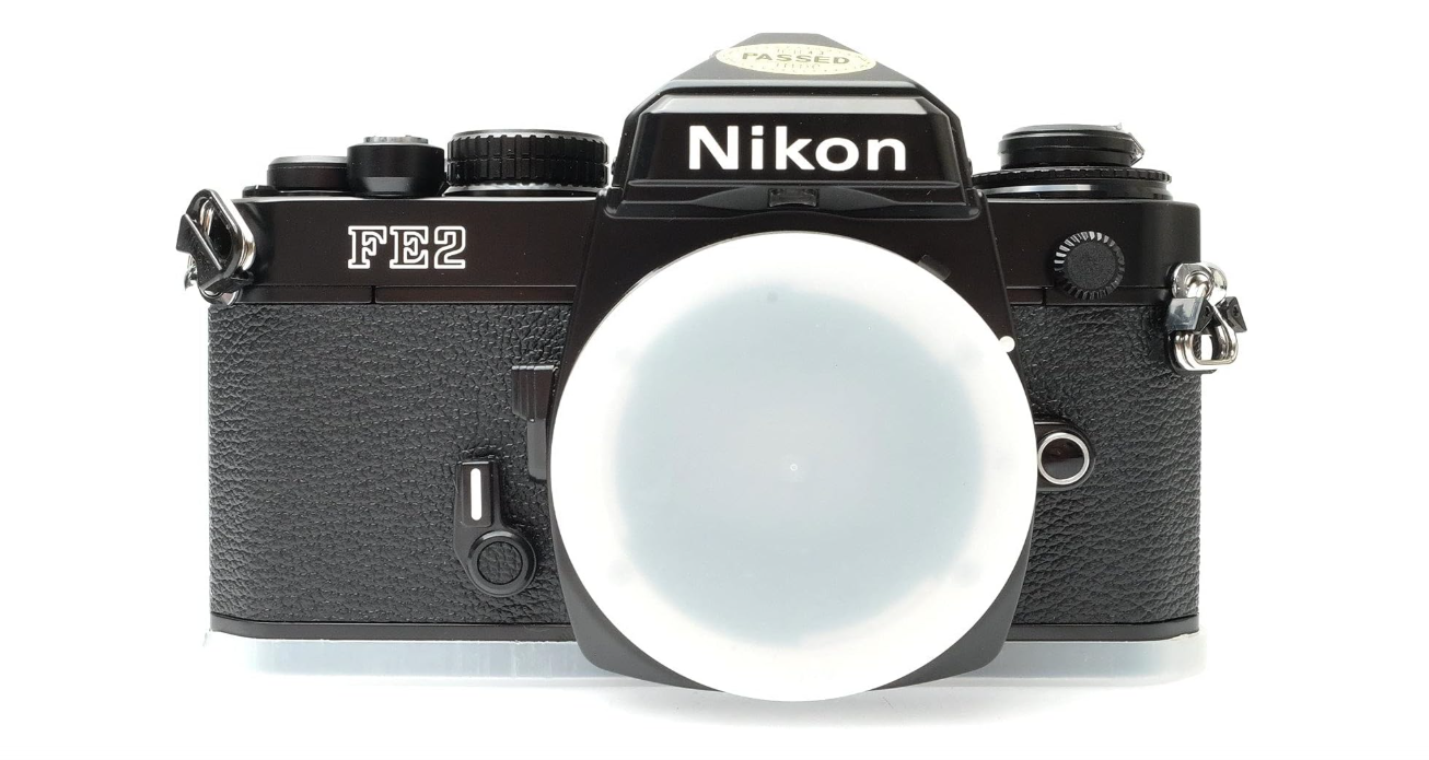 Nikon FE2 film SLR camera with black body; no lens
