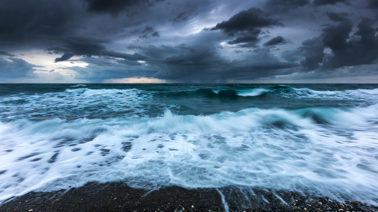 Dramatic waves crashing on pebbled shore symbolizing time's relentless march in Shakespeare's Sonnet 60.