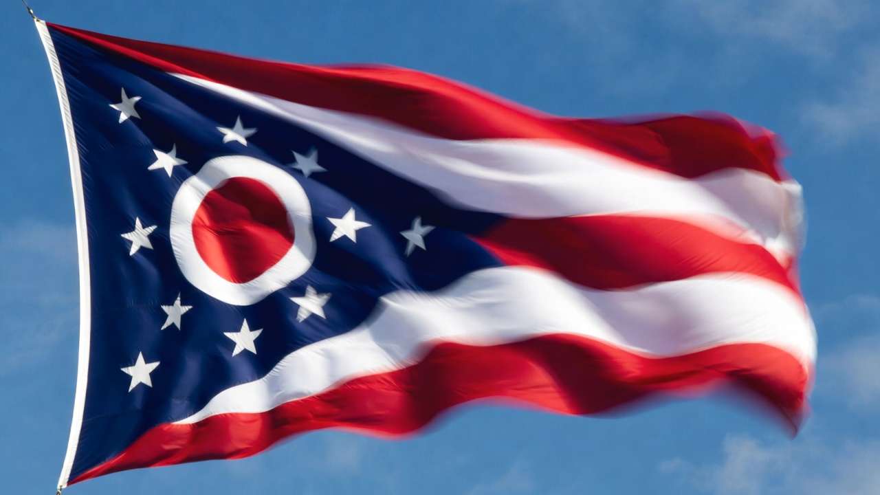 Ohio state flag waving, representing state laws on Romeo and Juliet close-in-age exemption.