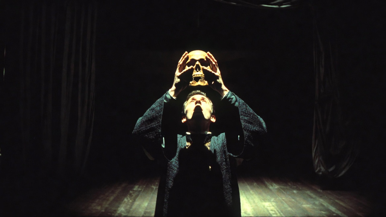 Iconic Hamlet with skull stage performance moment under spotlight in theater history