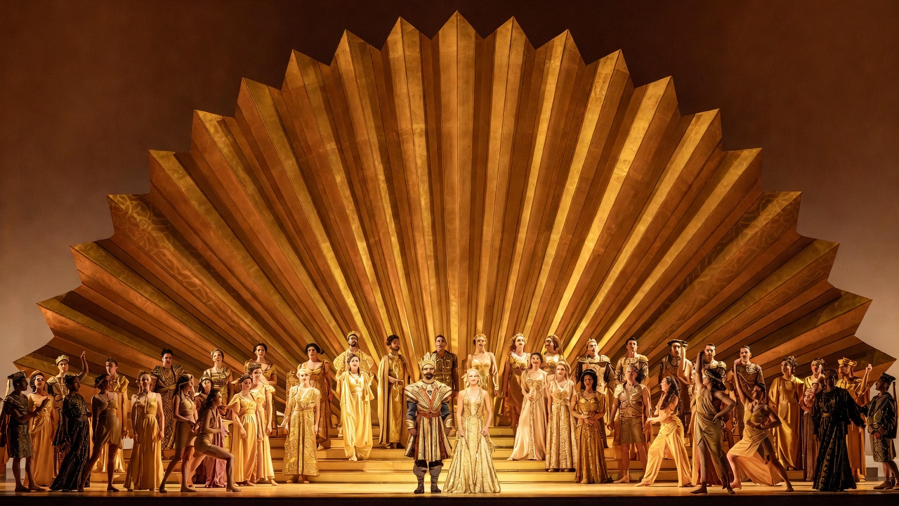 Grand spectacle scene with golden sunburst backdrop in Elkhanah Pulitzer's staging of John Adams Antony and Cleopatra at the Met Opera 2025