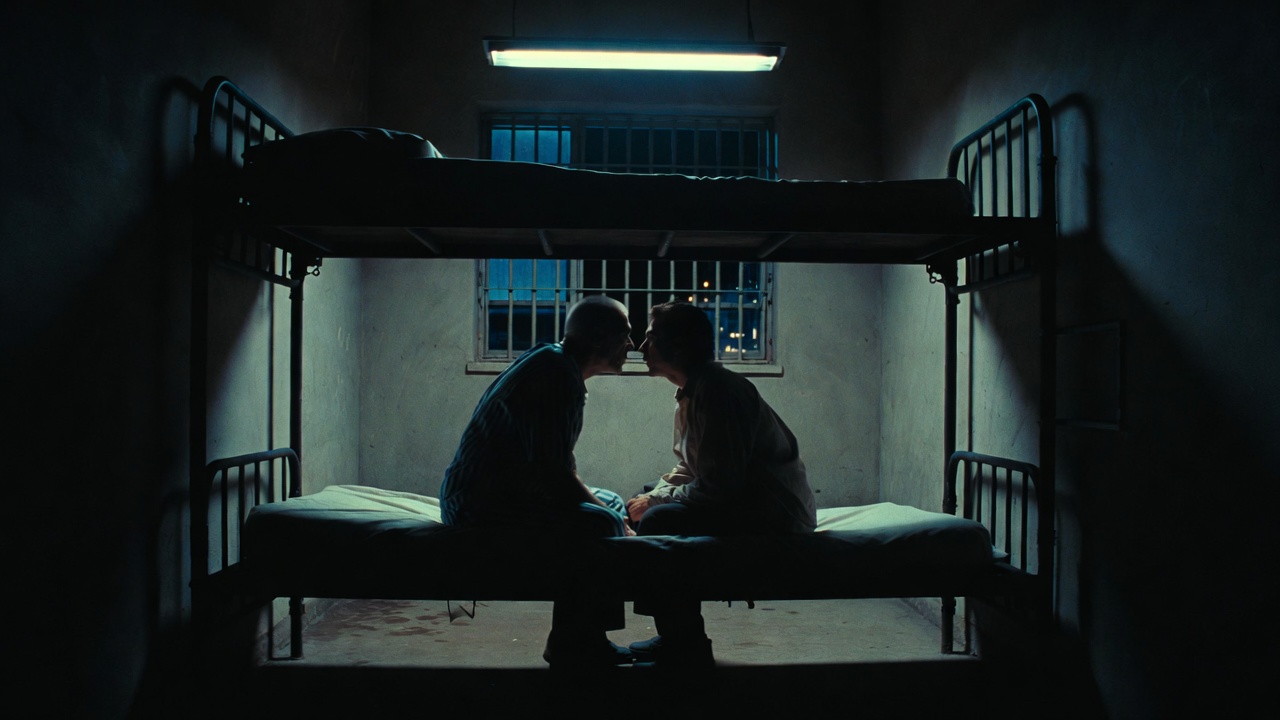 Dimly lit jail cell showing confidential conversation between two inmates illustrating jailhouse informant dynamic in United States v. Henry