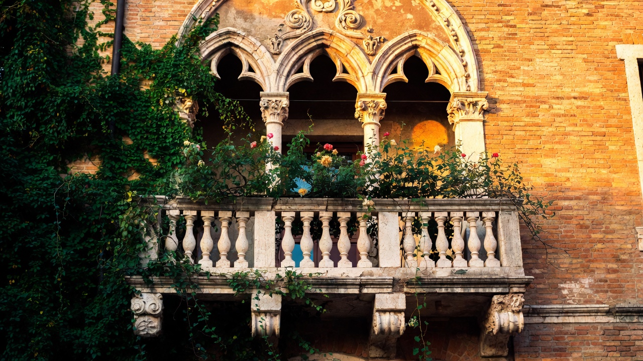 Iconic Renaissance stone balcony with ivy in Verona, evoking Juliet's famous scene in Romeo and Juliet