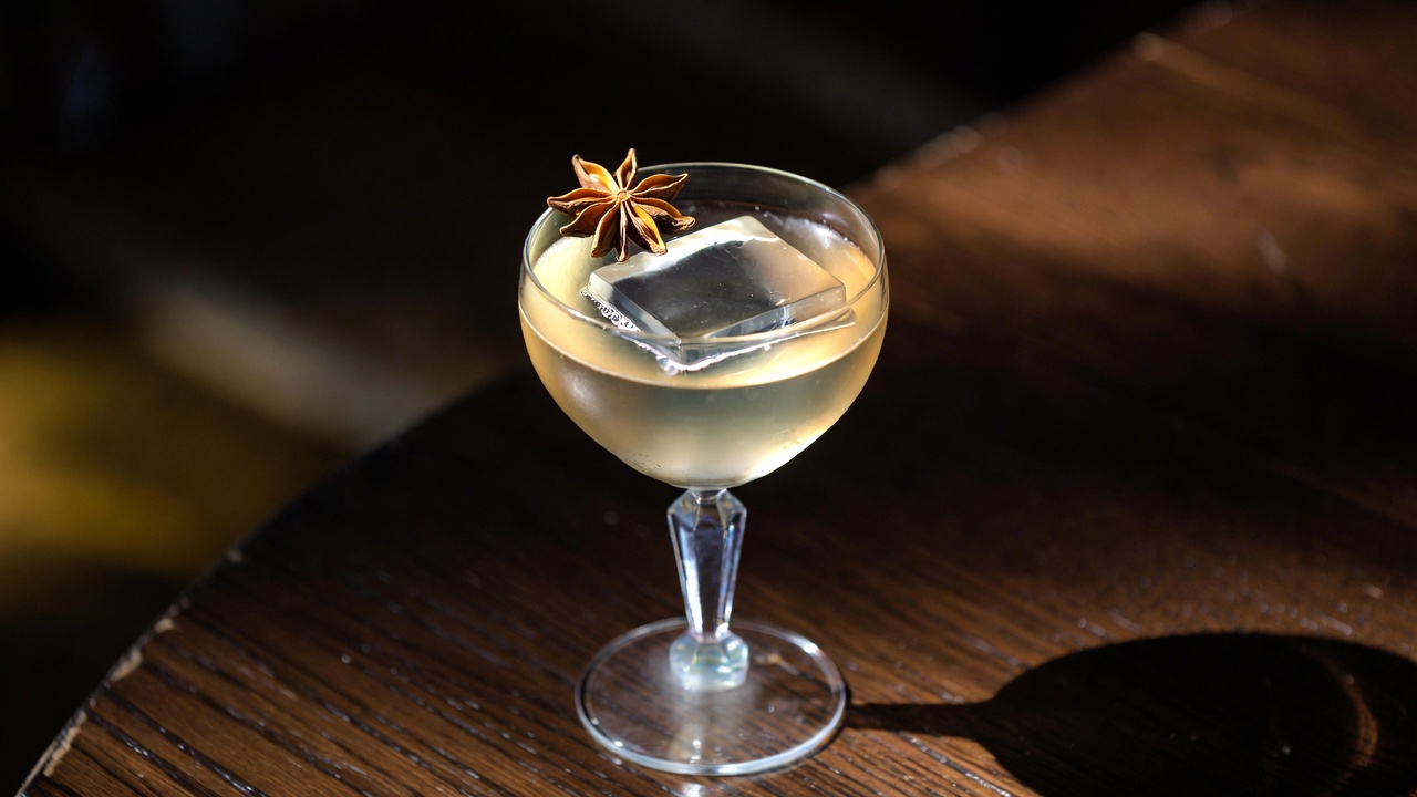 Clarified milk punch signature cocktail at Hamlet & Ghost, elegant and silky craft drink with ice and garnish.