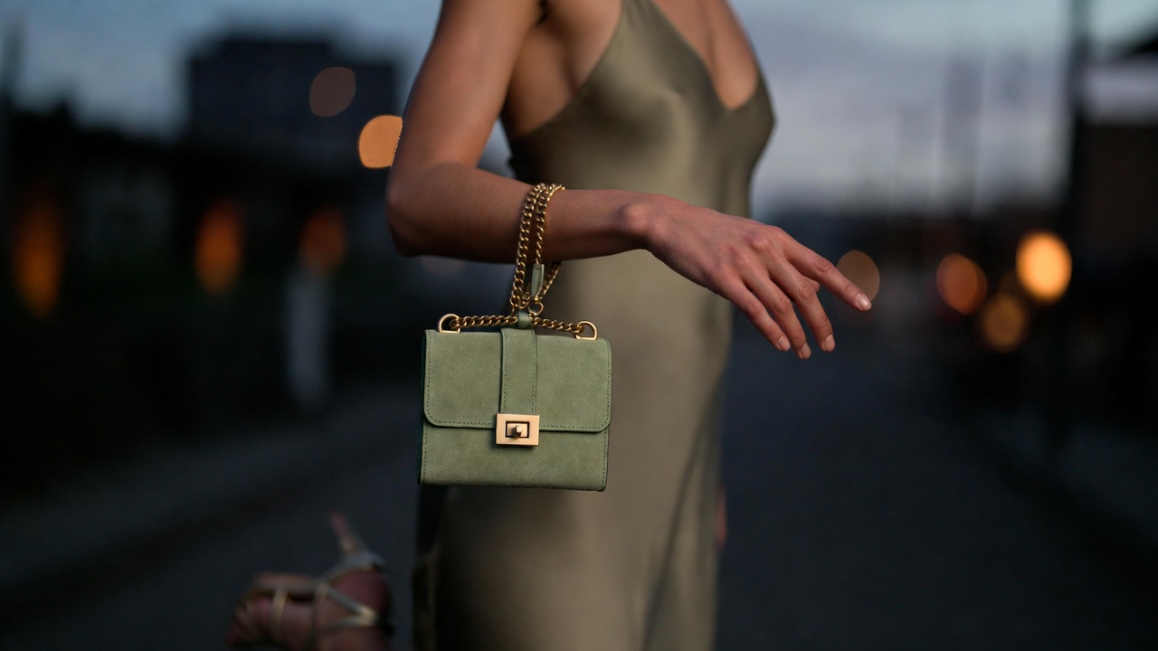 Clare V Henri Petit green suede wristlet styled for evening with silk dress, versatile luxury mini bag outfit inspiration.