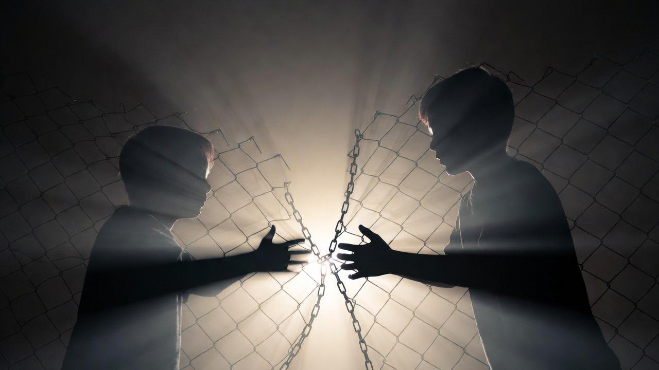 Breaking chain barrier between young silhouettes depicting real-life protection under Michigan Romeo and Juliet close-in-age exception