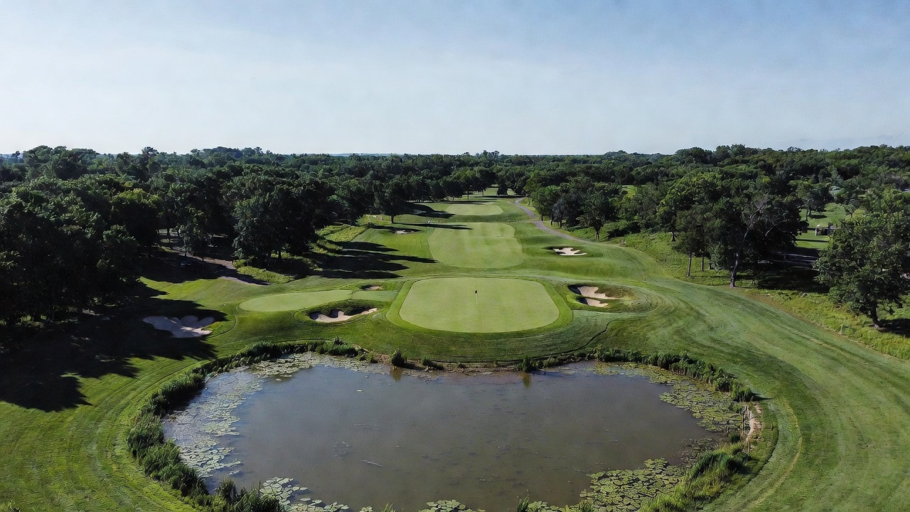 Challenging approach shot over water hazard to the green at Hamlet Golf Course Indiana, highlighting strategic play on this public Indiana golf course.