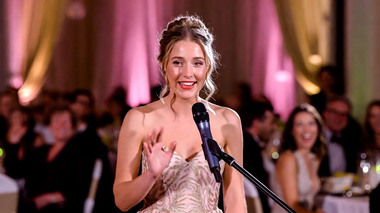 Sister giving funny and lighthearted maid of honor toast during wedding