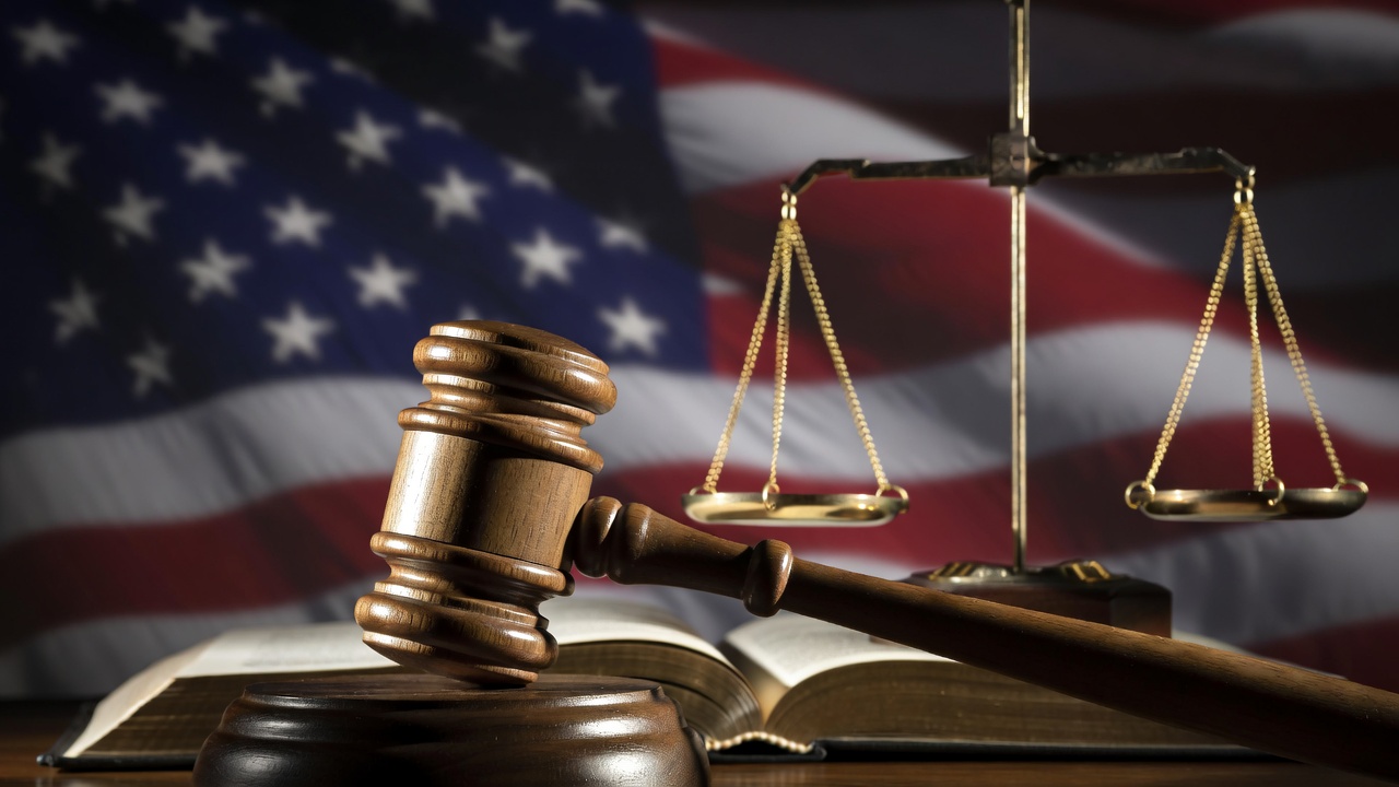 Gavel, scales of justice, and law book representing U.S. age of consent laws and statutory regulations.