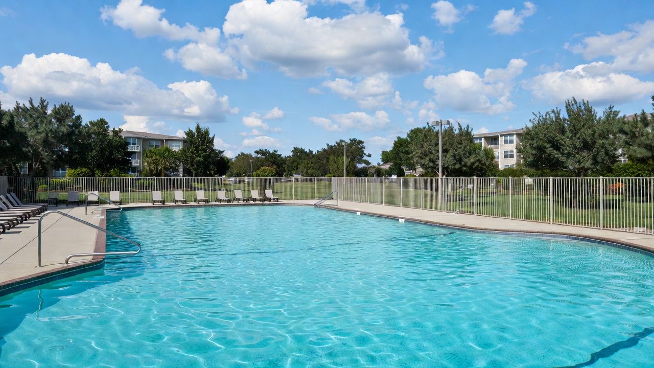 Seasonal swimming pool and lounge area at Hamlet West Apartments Baltimore community amenities.