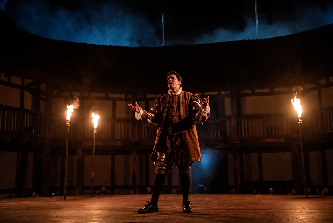 Shakespearean actor delivering soliloquy on Globe Theatre stage Elizabethan drama