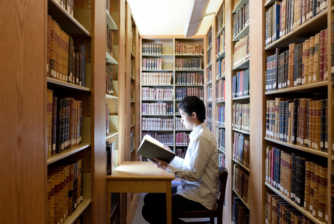Researcher examining rare books in Special Collections at James E. Morrow Library Marshall University