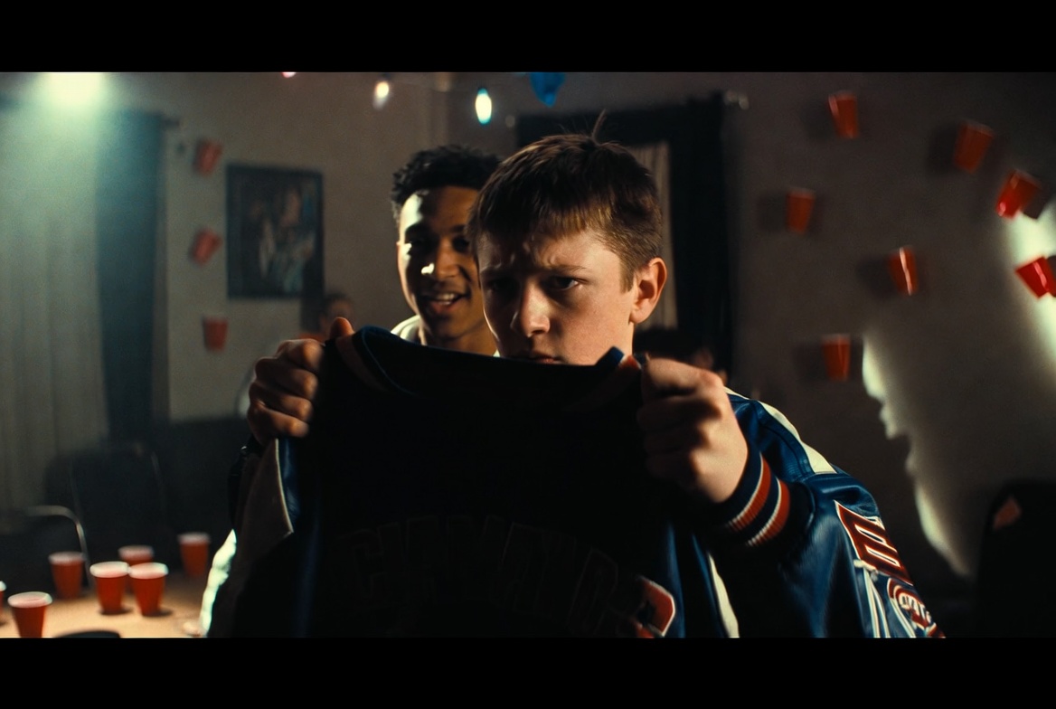 Championship jacket symbolism in Othello basketball movie adaptation O